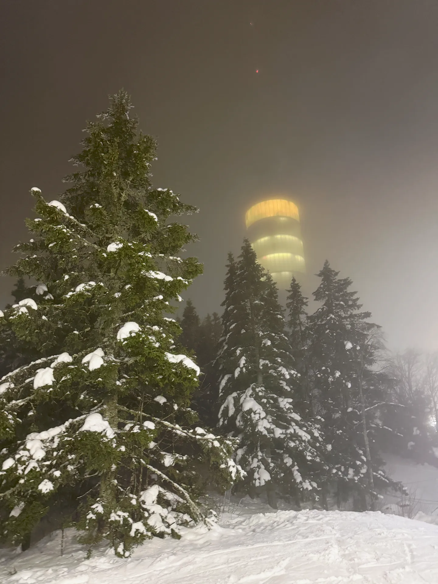 Ski slope with ominous building in the fog